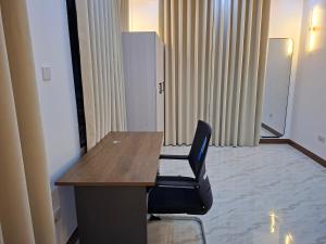a desk and a chair in a room at Serene BnB - Apt 05 Makongo after Mlimani City in Dar es Salaam +20 photos