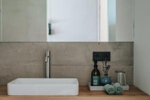 a white sink in a kitchen with a mirror at Langstrein Hof in Laces