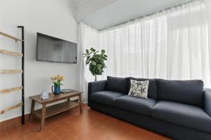 a living room with a blue couch and a table at Pr Rentals Walk To La Placita & Condado Beach in San Juan