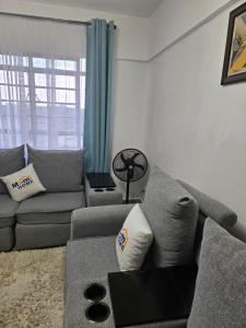 a living room with a couch and a table at Hami Ventures in Kisumu