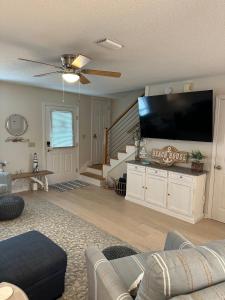 a living room with a large flat screen tv at Sea the Good in Panama City Beach