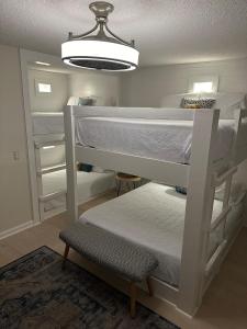 a room with two bunk beds and a light at Sea the Good in Panama City Beach +41 photos