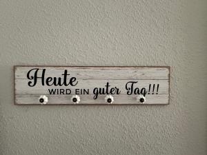 Un cartel en una pared que dice "Hospice Wind End Em Caller Tag" en Landhof est 1886, en Niederdorla