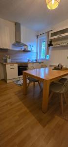 a kitchen with a wooden table and a wooden floor at FeWo Oahu in Meisenheim