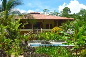 a house with a garden in front of it at Bluff Beach Retreat in Bocas del Toro