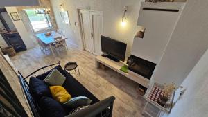 a living room with a couch and a television at Villa Brač in Sumartin