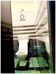 a bathroom with a toilet and a sink at Hotel P-V-R 50 Meters Only From Railway Station With Free Internet Services in Bhubaneshwar +11 photos
