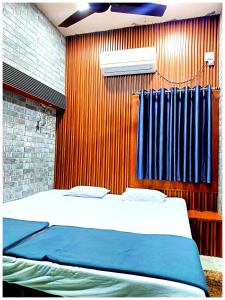 a bedroom with a bed and a window with a air conditioner at Hotel P-V-R 50 Meters Only From Railway Station With Free Internet Services in Bhubaneshwar +14 photos