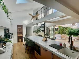 a kitchen with a kitchen island with a counter top at La Petite Cabine, 3chambres proche plage et centre in Les Sables-dʼOlonne