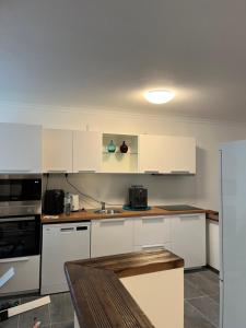 a kitchen with white cabinets and a counter top at Charmante Wohnung Appartement in Ulm in Ulm