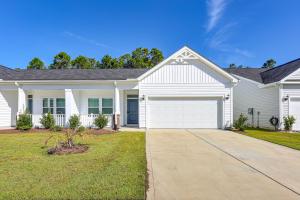 a white house with a driveway at 3 Mi to Sand! Ocean Isle Beach Escape Near Golf in Seaside