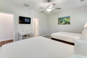 a bedroom with two beds and a ceiling fan at 3 Mi to Sand! Ocean Isle Beach Escape Near Golf in Seaside