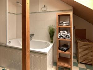 a bathroom with a bath tub and a sink at Haus Freigeist - zum Ortsblick in Neinstedt