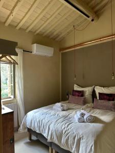 a bedroom with a large bed with towels on it at Le Porrine in Castelnuovo di Val di Cecina