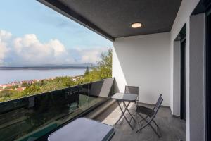 a balcony with chairs and a view of the water at Villa Eva in Dramalj