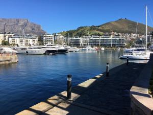 a marina with boats in the water and buildings at Gordons Guesthouse in Cape Town