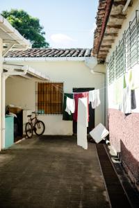 a building with clothes hanging on a clothes line at Hostal Casa del Sol in Suchitoto +16 photos