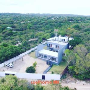 an aerial view of a large white house at Suite em Pipa com Hidro e Piscina in Pipa +4 photos