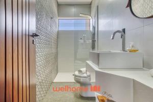 a bathroom with a shower and a toilet and a sink at Suite em Tibau do Sul proxima a praia das Minas in Pipa