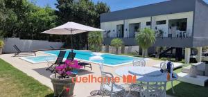 a villa with a swimming pool and a house at Suite em Tibau do Sul proxima a praia das Minas in Pipa +3 photos