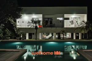 a villa with a swimming pool at night at Suite em Pipa com piscina incrivel em Mansao in Pipa