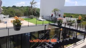 a view from the balcony of a building with flowers at Suite em Pipa com piscina incrivel em Mansao in Pipa