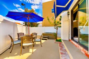 a patio with a table and chairs and an umbrella at Perfect Newport Beach Location With Spa I in Newport Beach
