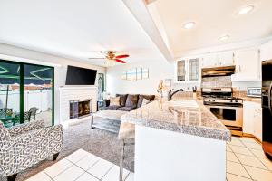 a kitchen and living room with a fireplace at Perfect Newport Beach Location With Spa I in Newport Beach