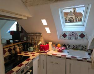 a kitchen with a sink and a window at L'Étoile in Moret-sur-Loing
