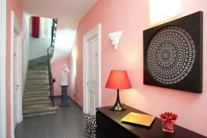 a room with pink walls and a desk with a lamp at Palazzo Lombardo in Florence