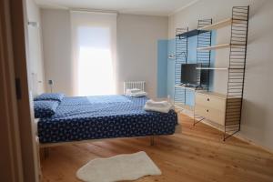 a bedroom with a bed and a book shelf at Palazzo Righi in Carisolo