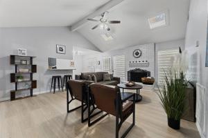 a living room with a couch and a fireplace at Spacious Humble Retreat - Near IAH & Lake Houston - Sleeps 9 in Humble