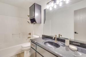 a bathroom with a sink and a toilet and a mirror at Fenced-In Yard Family Home 4 Mi to Dtwn Killeen! in Killeen +19 photos
