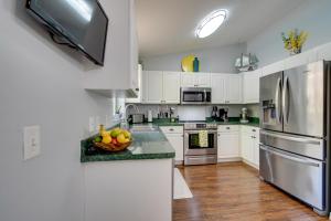 a kitchen with white cabinets and a bowl of fruit on the counter at Private Heated Pool Sunny Homosassa Stay! in Homosassa