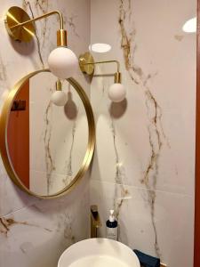 a bathroom with a gold mirror and a sink at Casa Paloma in Sanary-sur-Mer +18 photos