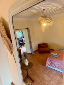 a room with a mirror and a chair and a table at Casa Paloma in Sanary-sur-Mer