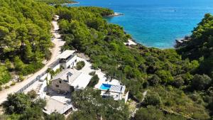 an aerial view of a house on a hill next to the ocean at Villa Brač in Sumartin