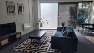 a living room with a couch and a tv at Beautiful studio near the station in London