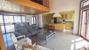 a living room with a couch and a table at Casa do Miradouro in São Brás de Alportel