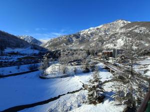 a snow covered valley with a river and mountains at Appartamento panoramico in montagna Alpi Bardonecchia in Bardonecchia +27 photos