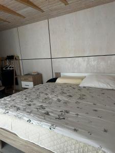 a bedroom with a large white bed in a room at Modern holiday home in Teplička nad Váhom