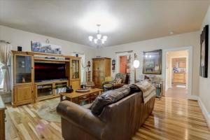 a living room with a couch and a television at Relax & Reboot 