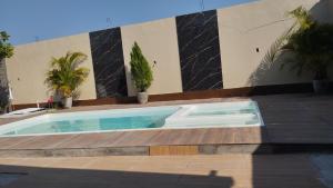 a swimming pool in front of a building at Inn R1 Pousada e Passeios in Barreirinhas