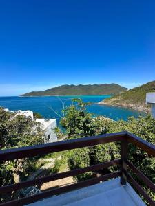 a view of the ocean from a balcony at Greek House Premium in Arraial do Cabo