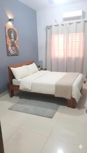 Кровать или кровати в номере Appartement Moderne PanneaUx Solaires Golf, Bamako