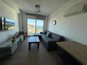 a living room with a couch and a table at North Residence Sea View Cozy Home in Kyrenia