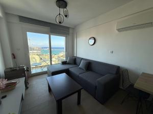 a living room with a couch and a table at North Residence Sea View Cozy Home in Kyrenia
