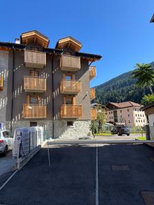 a building with balconies and a parking lot at Palazzo Righi in Carisolo