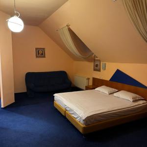 a bedroom with a bed and a chair at Vila Daria in Braşov