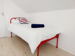 a white bed in a room with a red frame at 8 Eden Villa in Yzerfontein +17 photos